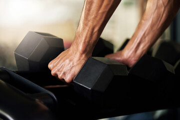 Hands, training and man exercise with weights in a gym for strength, wellness and health for...