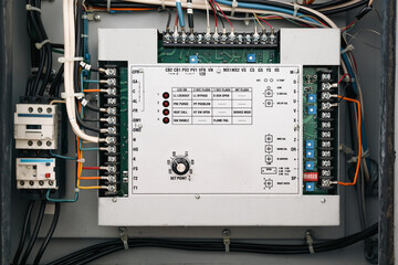 Hvac control panel or temperature regulating equipment. Open make-up air unit electrical closet on rooftop of residential or commercial strata building. Open electrical cabinet. Selective focus.