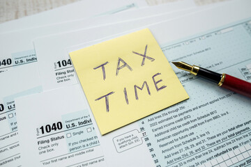 yellow sticker with world Tax Time on 1040 tax form