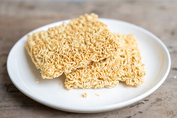Delicious instant noodles on white plate on white background