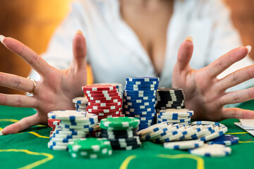 woman in a casino with chips that she wraps after a big win in casino poker.