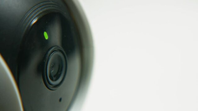 Macro Close Up of Home Security Camera Panning Left to Right Observing Area