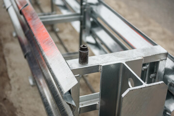 Metal road fencing of barrier type on freeway. Road guard rails. Safety barrier with a red and white striped sign. Installation of median crash barriers on highway. Protect vehicles from accidents.