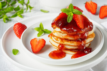 Mini pancakes with strawberry jam and strawberries