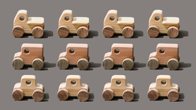 Wooden toy cars on gray background
