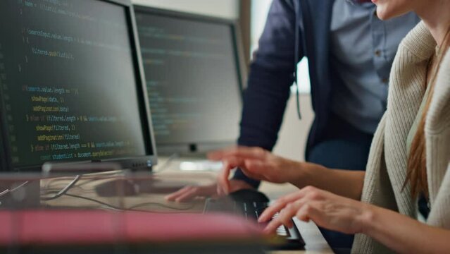It programmers discussing project in office closeup. Hands typing computer code