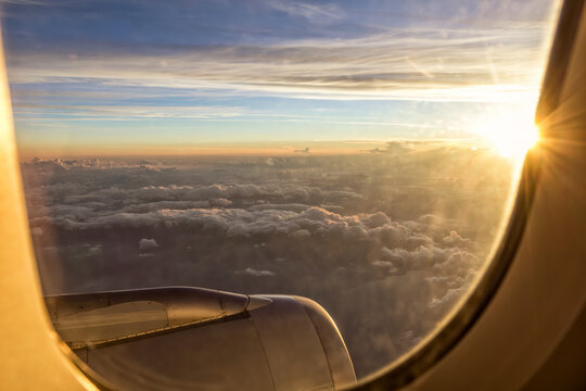 Cloudscape from aircraft window at sunset