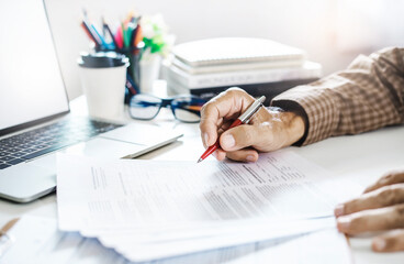 Businessman working on laptop reviewing document reports reading email and meeting online. legal expert, professional lawyer reading and checking financial documents or insurance contract