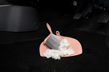 use broom and trash shovel to clean in the carpet area under the accelerator pedal and car coupling	