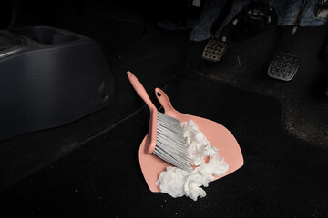 use broom and trash shovel to clean in the carpet area under the accelerator pedal and car coupling	