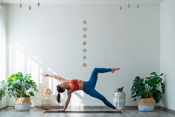 Woman practicing Ardha Chandrasana yoga pose