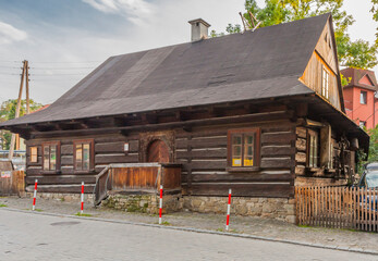 Wooden traditional highlander's hut, which houses the ethnographic museum Stara Zagroda in Ustroń in the Silesian Beskids (Poland). - obrazy, fototapety, plakaty