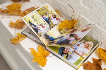 dry autumn leaves and a photo album