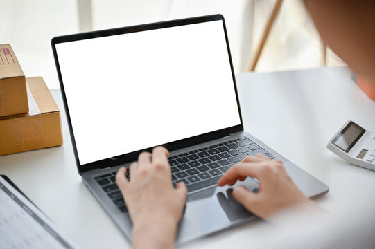 Close-up image of a female online business owner confirming orders on the website