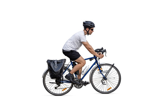 Cyclist riding a touring bicycle equipped with panniers - isolated from background