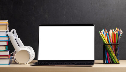 Laptop, books and pencils on desk