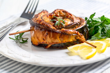 Baked mackerel fillet in the form of a roll.