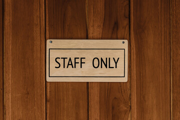 STAFF ONLY wood text badge sign banner on wooden door panel background.