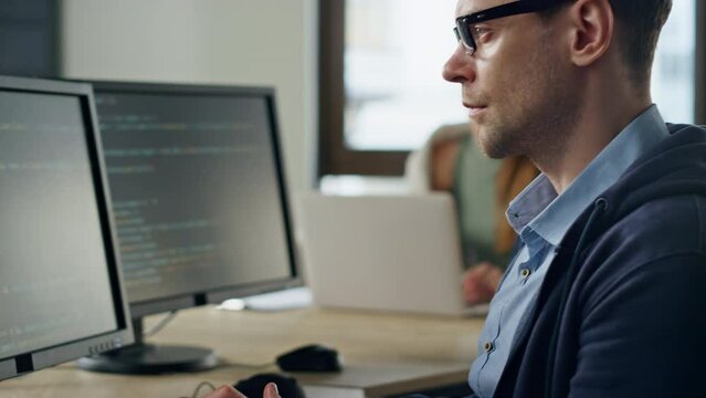 Closeup developer hands coding in office. Focused it man programming software