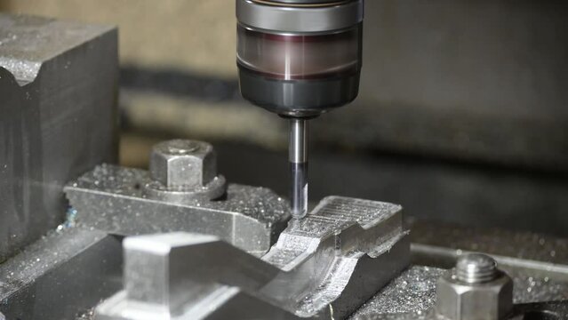 The CNC milling machine cutting injection mold part with ball end mill tool.