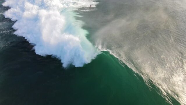 Drone top-down close-up view over huge ocean waves crashing on G-Land, Grajagan Bay, Java, Indonesia, slow motion