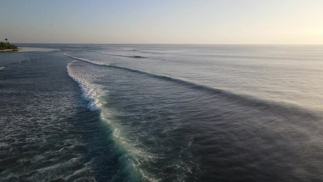 Aerial drone view over ocean waves on the tropical island coastline, G-Land, Grajagan Bay, Plengkung Beach, Java, Indonesia