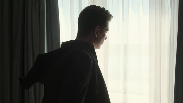 Business man put suit on during morning routine at home, preparing to go to work