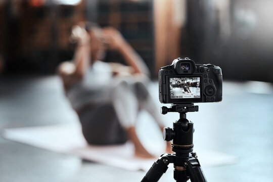 Recording, fitness and woman with a camera, exercise and training with form, vlogger and influencer. Female person, girl and athlete with health, live streaming workout and wellness with technology - Powered by Adobe