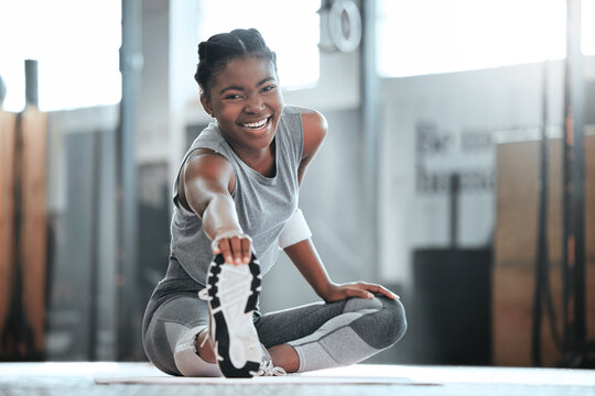 Gym, happy or portrait of black woman stretching legs for workout or body movement for active fitness. Smile, athlete or healthy girl smiling in exercise training warm up for flexibility or mobility