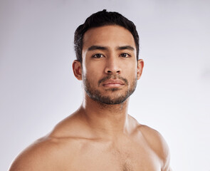 Confidence, portrait and young man in a studio after a workout or body strength training. Serious, sports and face of attractive male model with muscles after exercise isolated by a white background.