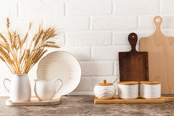 Beautiful front view of kitchen countertop with modern design, eco-friendly tableware and stylish decor. brick wall.
