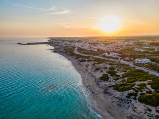 vista aerea del tramonto sulle dune di campomarino di maruggio in estate - taranto, salento,...