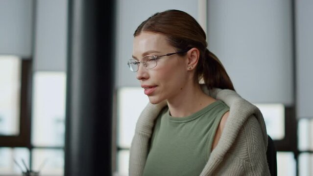 Startup employee working computer closeup. Focused woman searching data online