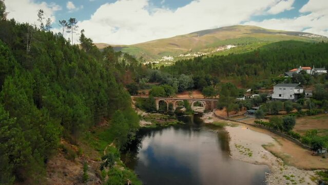 River with a Stone Bridge in a Summer Dav
