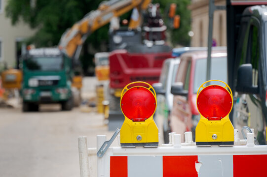 Two warning lamps mounted on roadblock at entrance to roadworks construction site