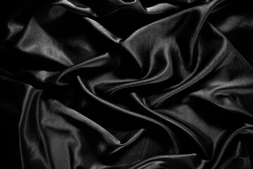 Fototapeta premium Black silk satin texture background.