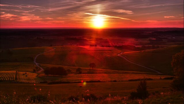 Timelapse. Sunset and nightfall over green valley, Pupillin commune in Jura region, Bourgogne-Franche-Comte in eastern France.
