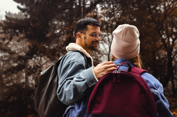 Portrait of couple spending time together walking in forest.