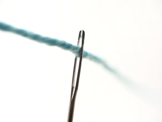 Sewing needle macro with thread on a white background 