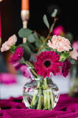 A bouquet of flowers in a vase. Decor details closeup. Decoration pink, flowers chrysanthemum, carnation for birthday party, wedding reception. Luxury event in a restaurant. Banquet hall.
