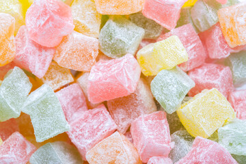 Closeup of multicolored cubes Turkish delight (Lokum). Selective Focus. Flat lay.