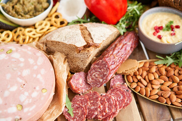 Salami sausage close-up. Table full of mediterranean appetizers, tapas or antipasto. Assorted Italian food set. Delicious snack on party or picnic time. Meat and cheese. Italian style banquet. 