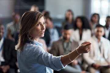 Presentation, training and coaching with a business woman talking to an audience during a workshop. Convention, speech and teaching with a female speaker giving a seminar to a group of employees - obrazy, fototapety, plakaty