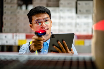 Warehouse workers use scanner checking and scan the barcode of stock inventory to keep storage in a system, Smart warehouse management system, Supply chain and logistic network technology concept.