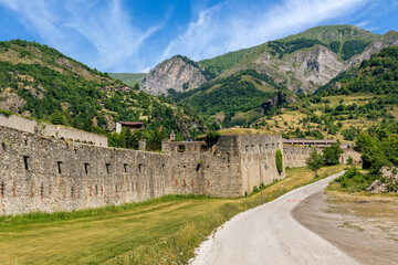 Narrow road and old military fort in the mountains in Italy.