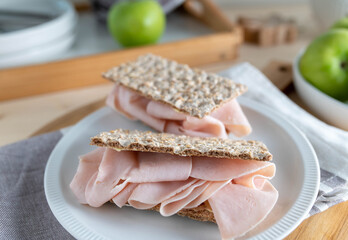 Low carb crispbread with chicken ham for breakfast on a plate