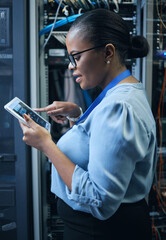 Obraz na płótnie Canvas IT woman, engineer and tablet in a server room for programming, cybersecurity or maintenance. Black female technician in datacenter for network, software or system upgrade app with technology