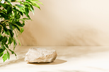 Product background with stone, green plant leaves and shadows on beige background, aesthetic showcase for product presentation