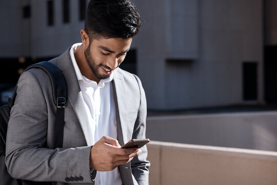 Happy, city connection and a businessman with a phone for social media, chat or reading an email. Smile, typing and an employee on a mobile app for a gps or notification during a morning commute