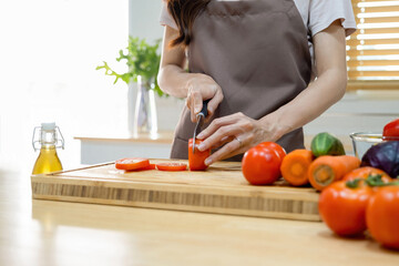 Obraz na płótnie Canvas Woman cutting vegetables ready for cooking.